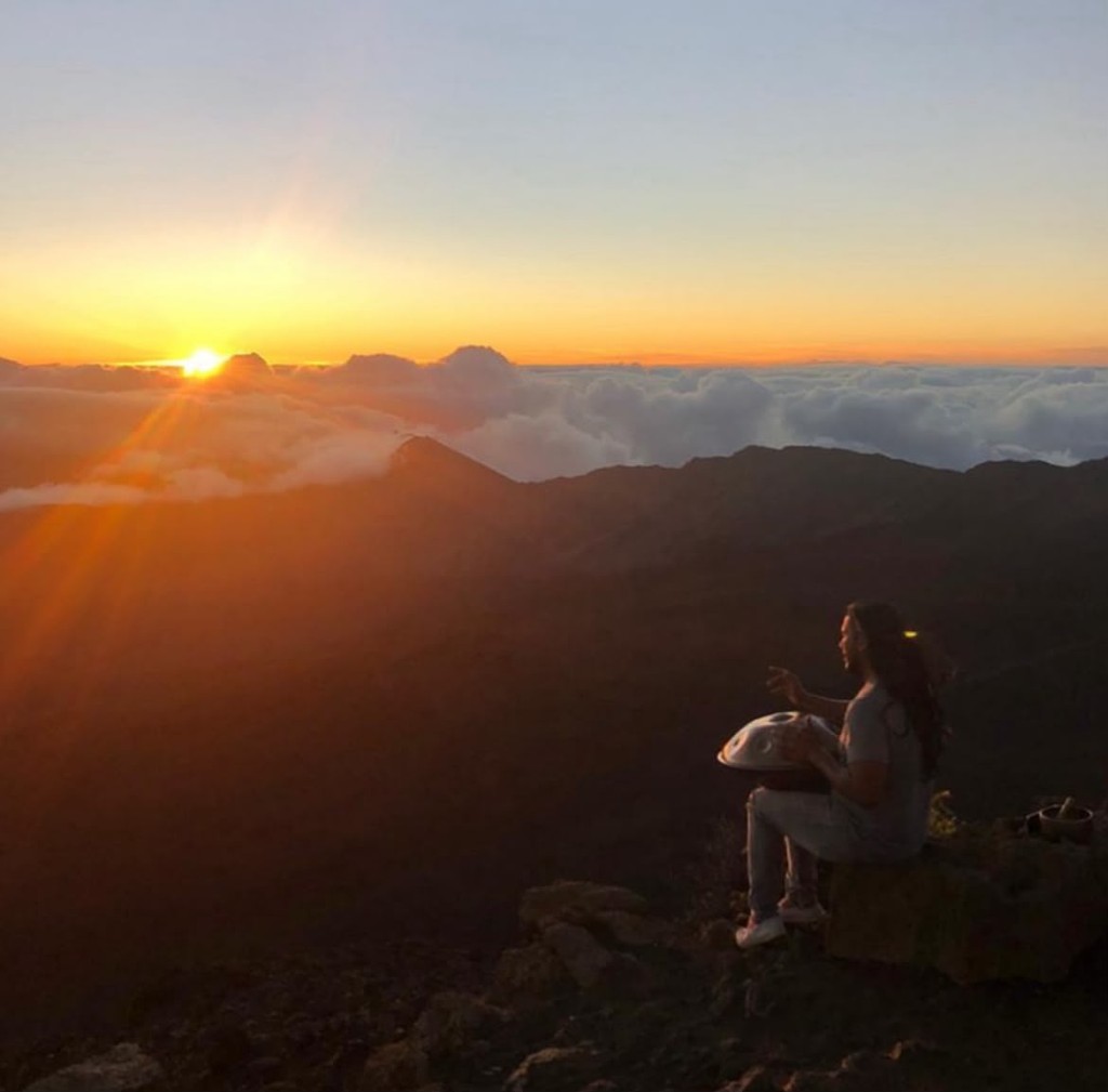 Handpan silhouette against mountain light